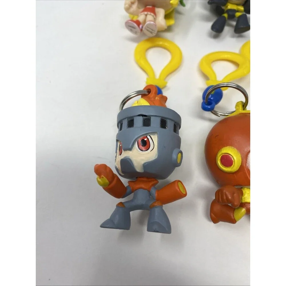 lot of 9 CAPCOM MEGA MAN BACKPACK HANGERS METALLIC FIRE MAN JUST TOYS INTL.
